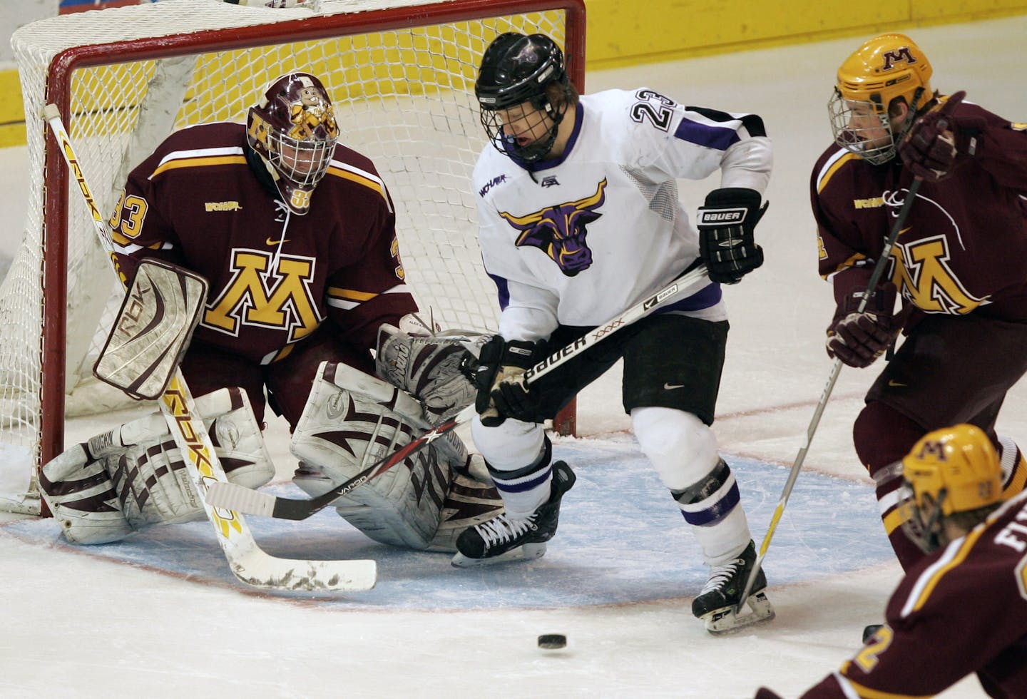 BRIAN PETERSON • brianp@startribune.com Mankato, MN 3/16/2008 Minnesota gophers and Minnesota State Mankato battle it out to a 1 to 1 tie after the first period at Mankato. Uof M Goalie Alex Kangas stopped a shot by Mankato's #23 Trevor Bruess.