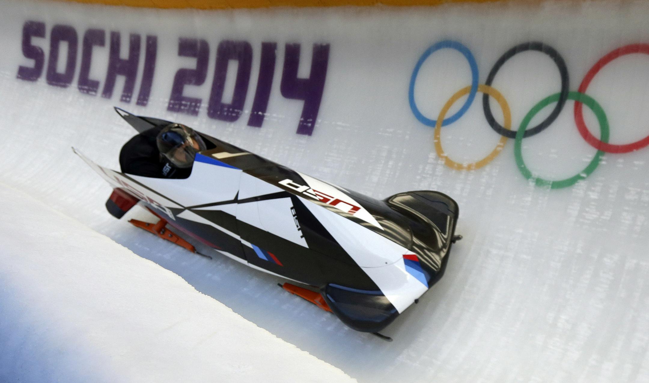 The two-man team from the United States USA-1, piloted by Steven Holcomb, speeds down the track during the men's two-man bobsled training at the 2014 Winter Olympics, Thursday, Feb. 13, 2014, in Krasnaya Polyana, Russia. (AP Photo/Natacha Pisarenko) ORG XMIT: MIN2014022012050767