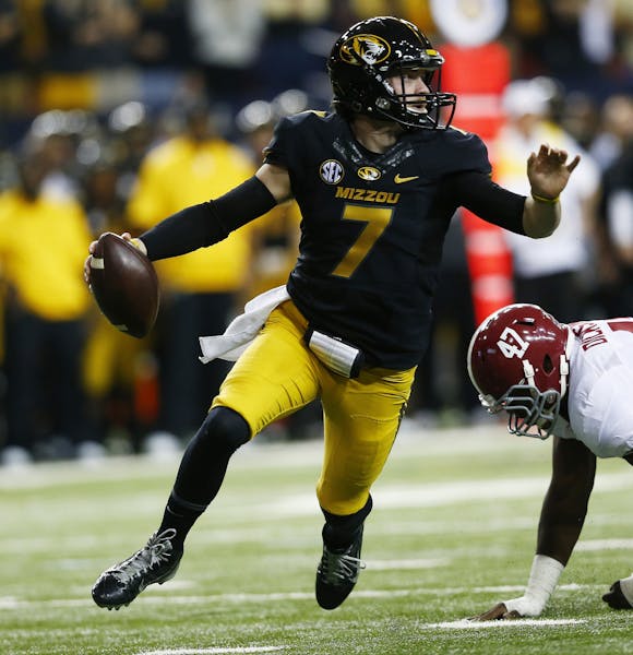 Missouri quarterback Maty Mauk (7) runs out of the pocket as Alabama linebacker Xzavier Dickson (47) defends during the first half of the Southeastern