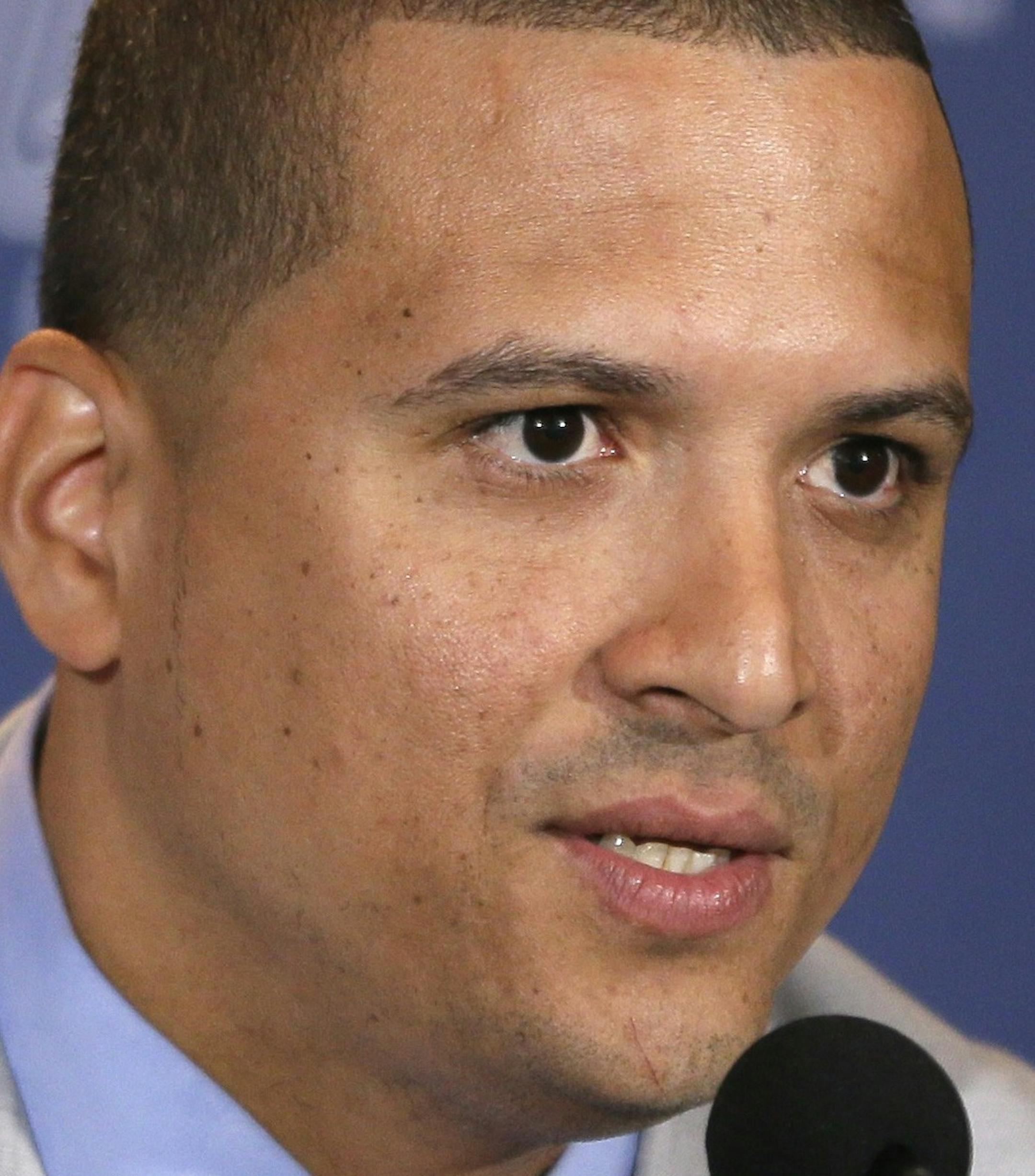 FILE - In this Nov. 14, 2014, file photo, Detroit Tigers designated hitter Victor Martinez addresses the media in Detroit, after agreeing to terms on a four-year contract through the 2018 season. Tigers slugger Victor Martinez needs surgery on his left knee after injuring it during his offseason workout program for the second time in four years The team said Thursday, Feb. 5, 2015, that Martinez tore the medial meniscus in his knee and is scheduled for surgery Tuesday with Dr. James Andrews in P