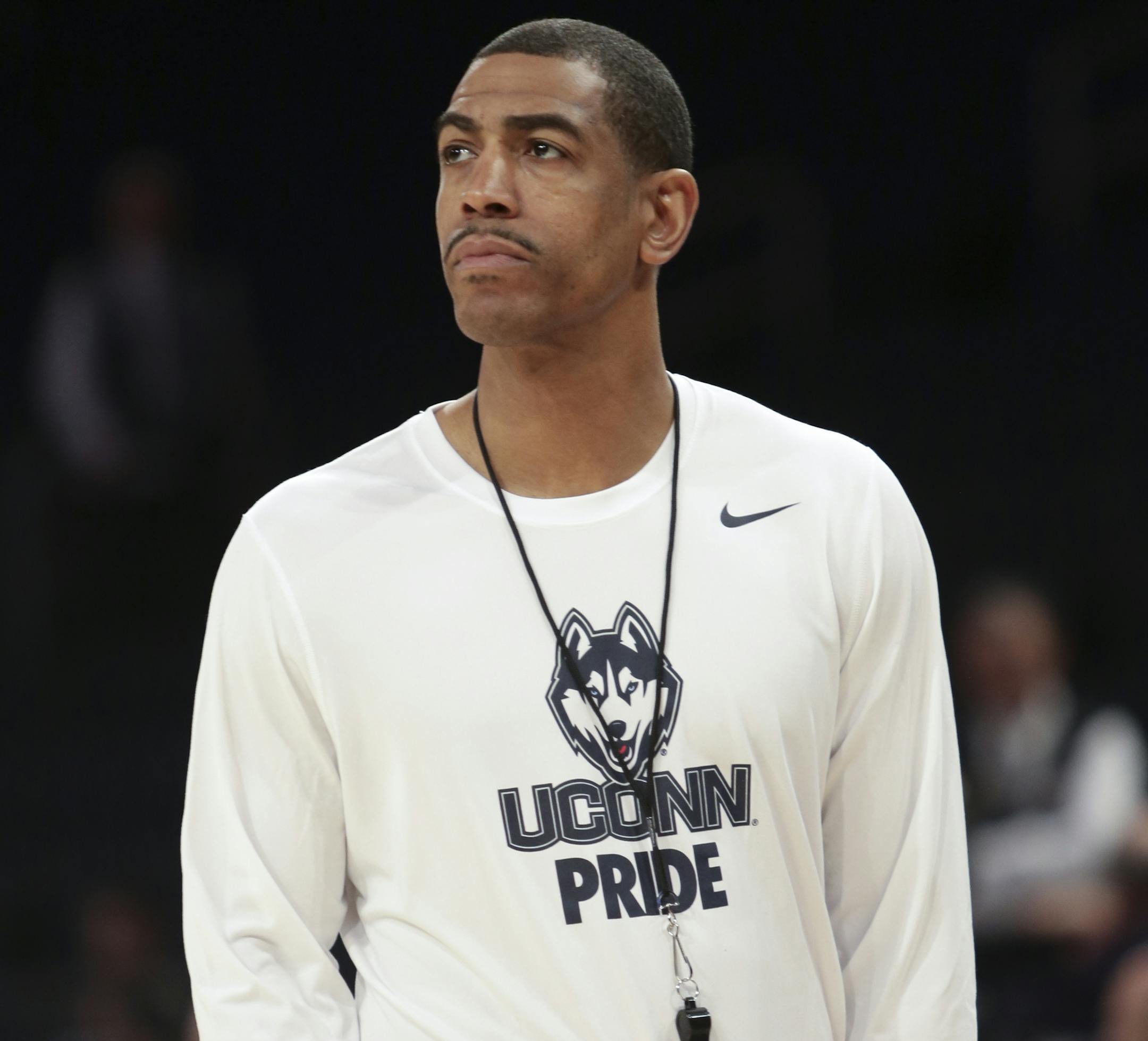Connecticut head coach Kevin Ollie watches his team during practice at the NCAA college basketball tournament in New York, Thursday, March 27, 2014. Connecticut will play Michigan State Friday. (AP Photo/Peter Morgan)