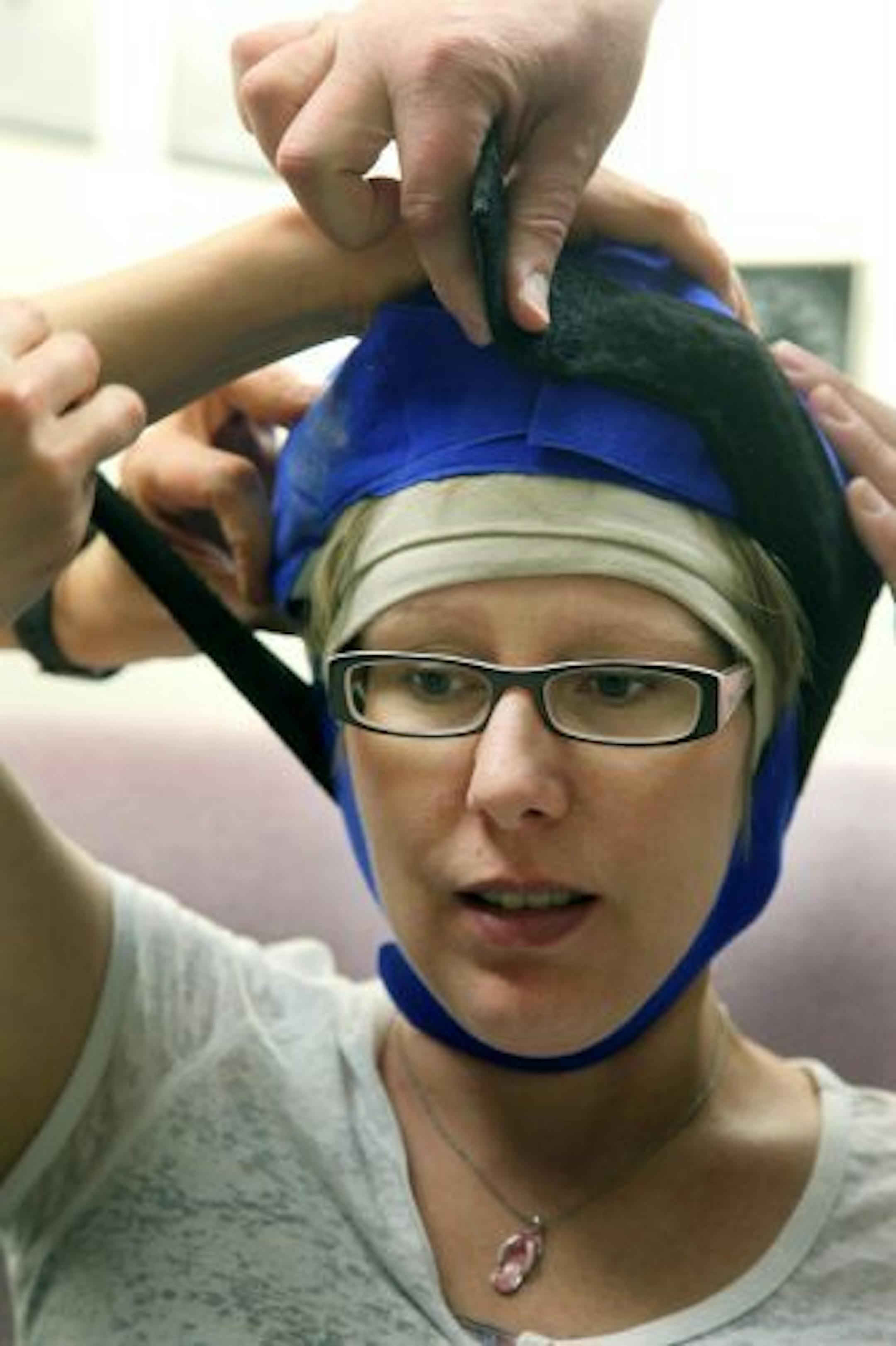 Chris Greene, helped place a chilled cap on his wife Carrie Greene.