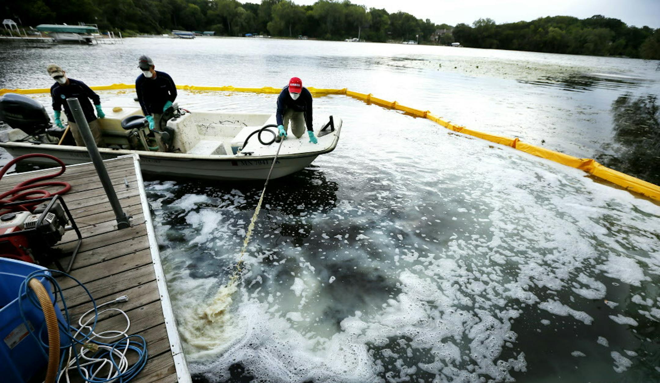 David Hillstrom treated an area on Christmas Lake for zebra mussels .Federal and state crews tested a product called Zequanox to try an control and infestation of zebra mussels on Christmas Lake Monday September 8 , 2014 in Shorewood, MN . A 50x60 feet section of the lake at the public access was treated . ] Jerry Holt Jerry.holt@startribune.com