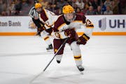Minnesota forward Jimmy Clark (23) launches for the puck at the game against Wisconsin in 3M Arena at Mariucci on Friday, Oct. 27, 2023 in Minneapolis