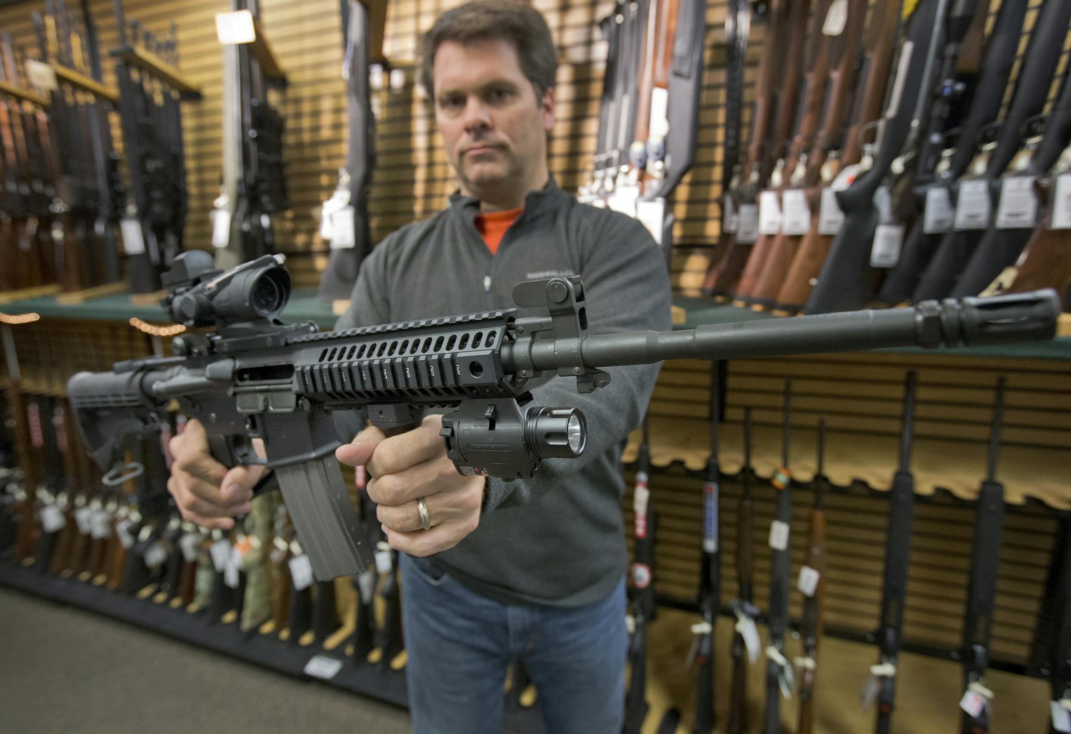 Jim Rauscher, president of Joe's Sporting Goods in Little Canada, held up a Colt AR-15 style rifle. He said people have been calling to ask: "What do you have on hand?" Applications for gun purchases and conceal-carry have gone up since the Connecticut school shooting.
