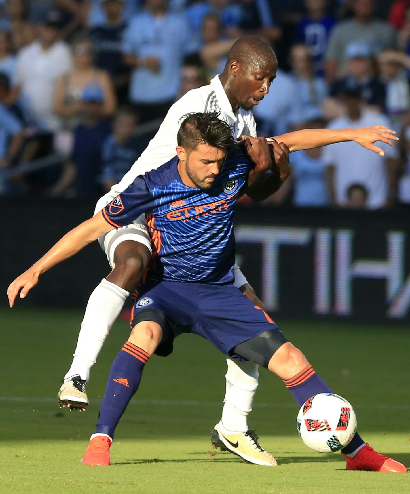 New York City FC forward David Villa (7) is challenged by Sporting Kansas City defender Ike Opara, back, during the first half of an MLS soccer match in Kansas City, Kan., Sunday, July 10, 2016. (AP Photo/Orlin Wagner)