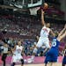 Maya Moore glides to the basket over France players during Team USA's gold gedal basketball game during the 2012 Summer Olympic Games in London.