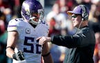 Minnesota Vikings head coach Mike Zimmer speaks to Chad Greenway in the first quarter of a game against the Washington Redskins on Sunday, Nov. 13, 20