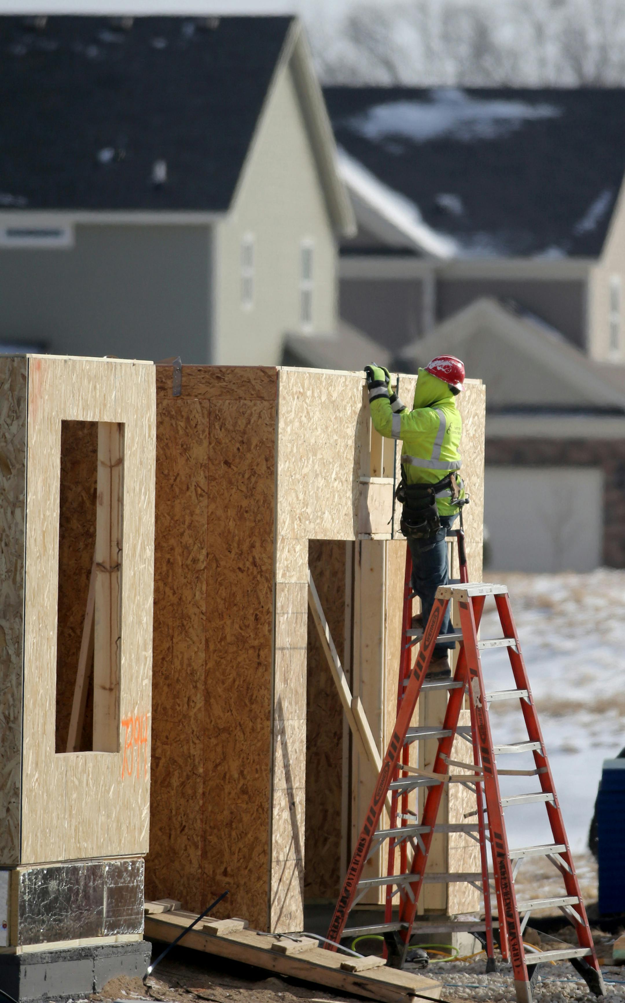 New single home construction in is full gear at Four Seasons at Rush Creek community. Here, Thursday, Feb. 26, 2015, in Maple Grove, MN. HEre a carpenter for Carpentry Contractors Co. of Montrose, MN, works on installing sheathing on a home under construction at the Four Seasons at Rush Creek community.]DAVID JOLES/STARTRIBUNE)djoles@startribune.com In a rush to beat the implementation of a new building code that is expected to increase the cost of a new house in the Twin Cities, area builders w