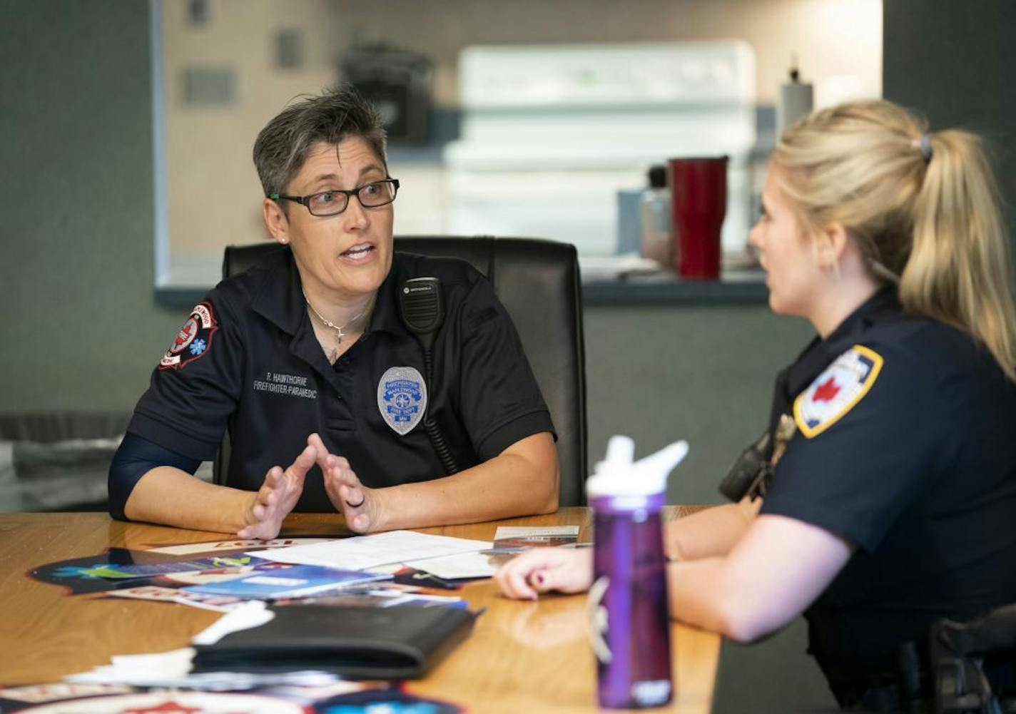 Firefighter paramedic Rochelle Hawthorne and officer Ashley Berger, who are both part of the mental health unit, discussed a plan for a "patient" before a meeting in Maplewood, Minn., on Thursday, June 27, 2019.