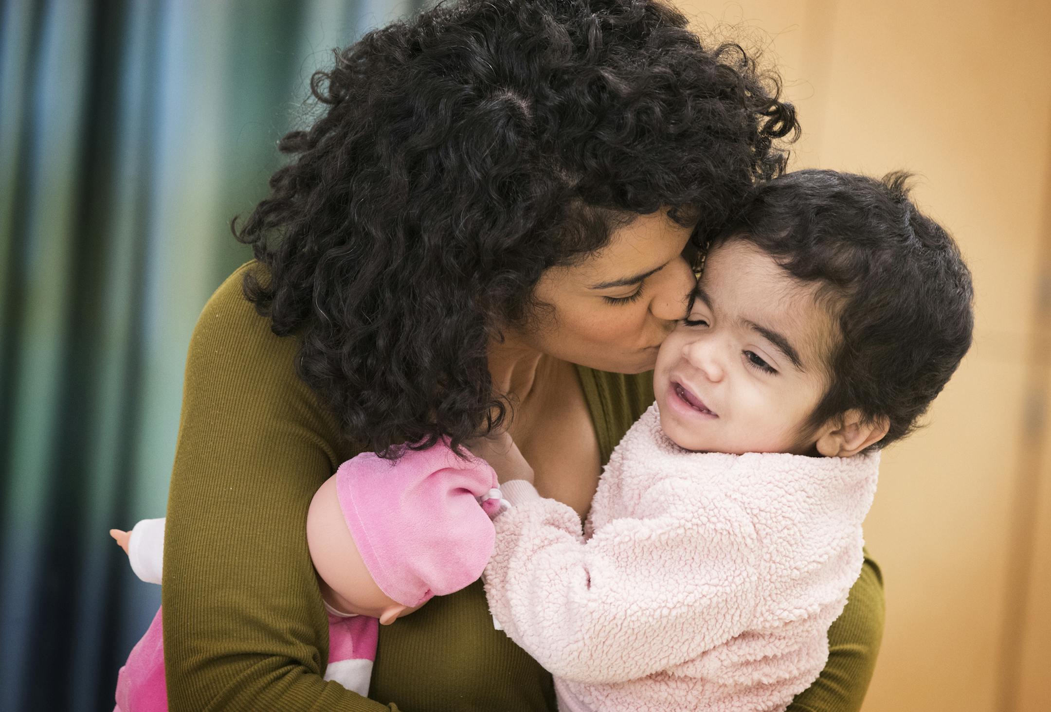 Juliette Marie, 2, hugs her mother Natalie Anaya during her physical therapy session. ] LEILA NAVIDI ï leila.navidi@startribune.com BACKGROUND INFORMATION: Juliette Marie, 2, does a physical therapy session at University of Minnesota Children's Masonic Hospital in Minneapolis on Wednesday, November 22, 2017. Two-year-old Juliette Marie was diagnosed with Hurler syndrome, a rare inherited metabolic disorder in which a person cannot break down long chains of sugar molecules called glycosamino