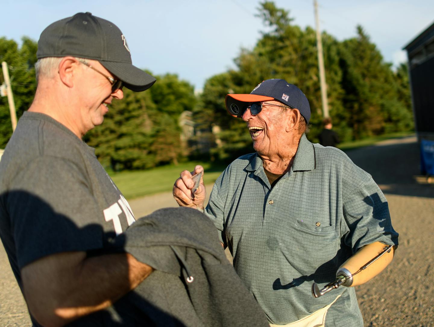 Baseball fans in Elrosa, Minn., pass through 92-year-old ticket taker Donnie Lenarz