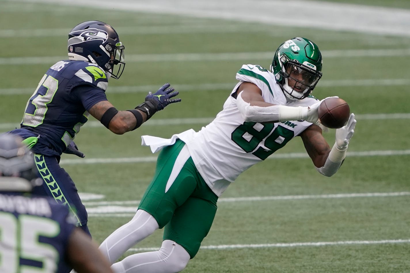 New York Jets tight end Chris Herndon (89) catches in front of Seattle Seahawks strong safety Jamal Adams during the first half of an NFL football game, Sunday, Dec. 13, 2020, in Seattle. (AP Photo/Ted S. Warren)