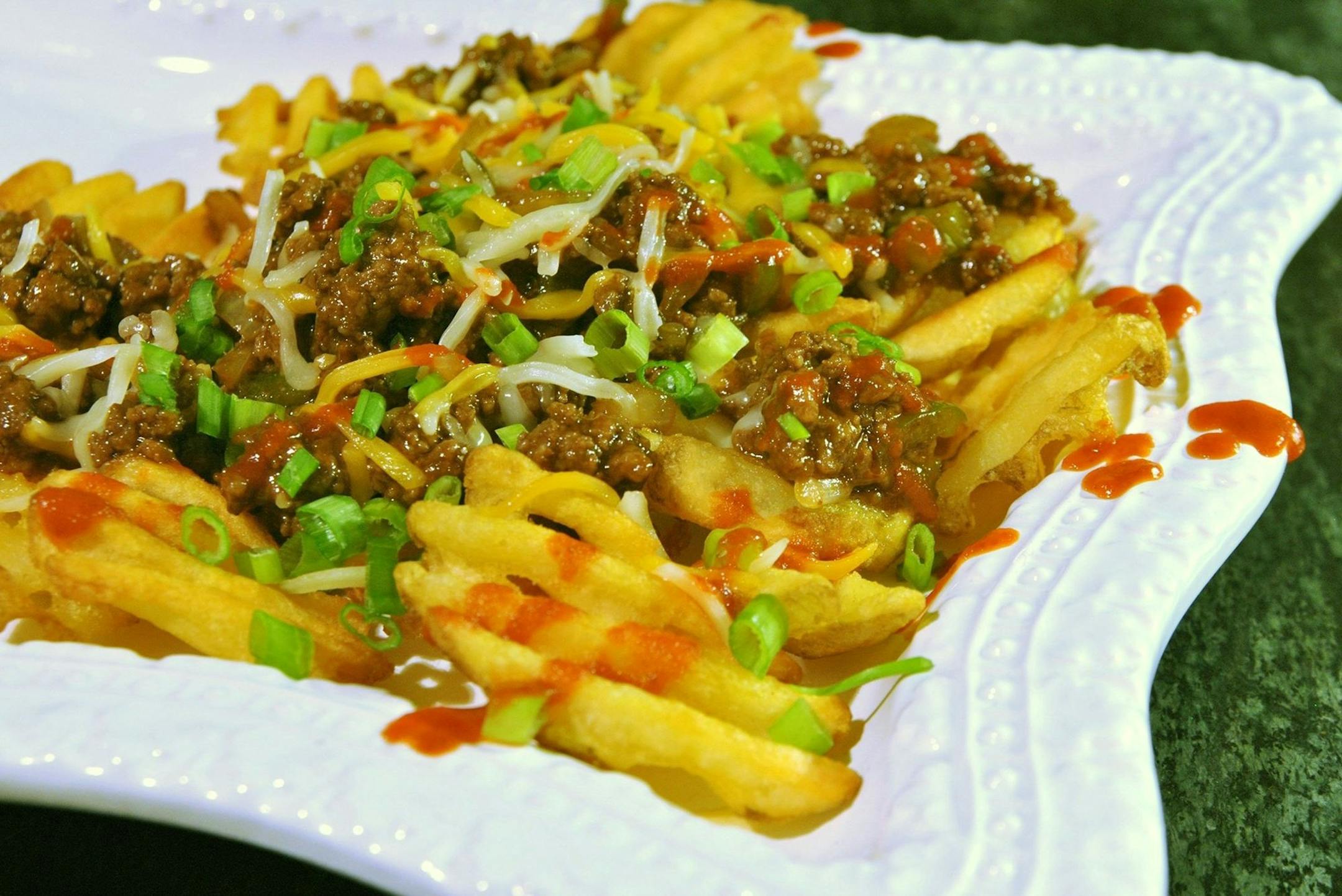 Sriracha Sloppy Joe Nachos on Waffle Fries offers a flavor twist to the traditional sloppy Joe recipe. (Gretchen McKay/Pittsburgh Post-Gazette/MCT) ORG XMIT: 1147920