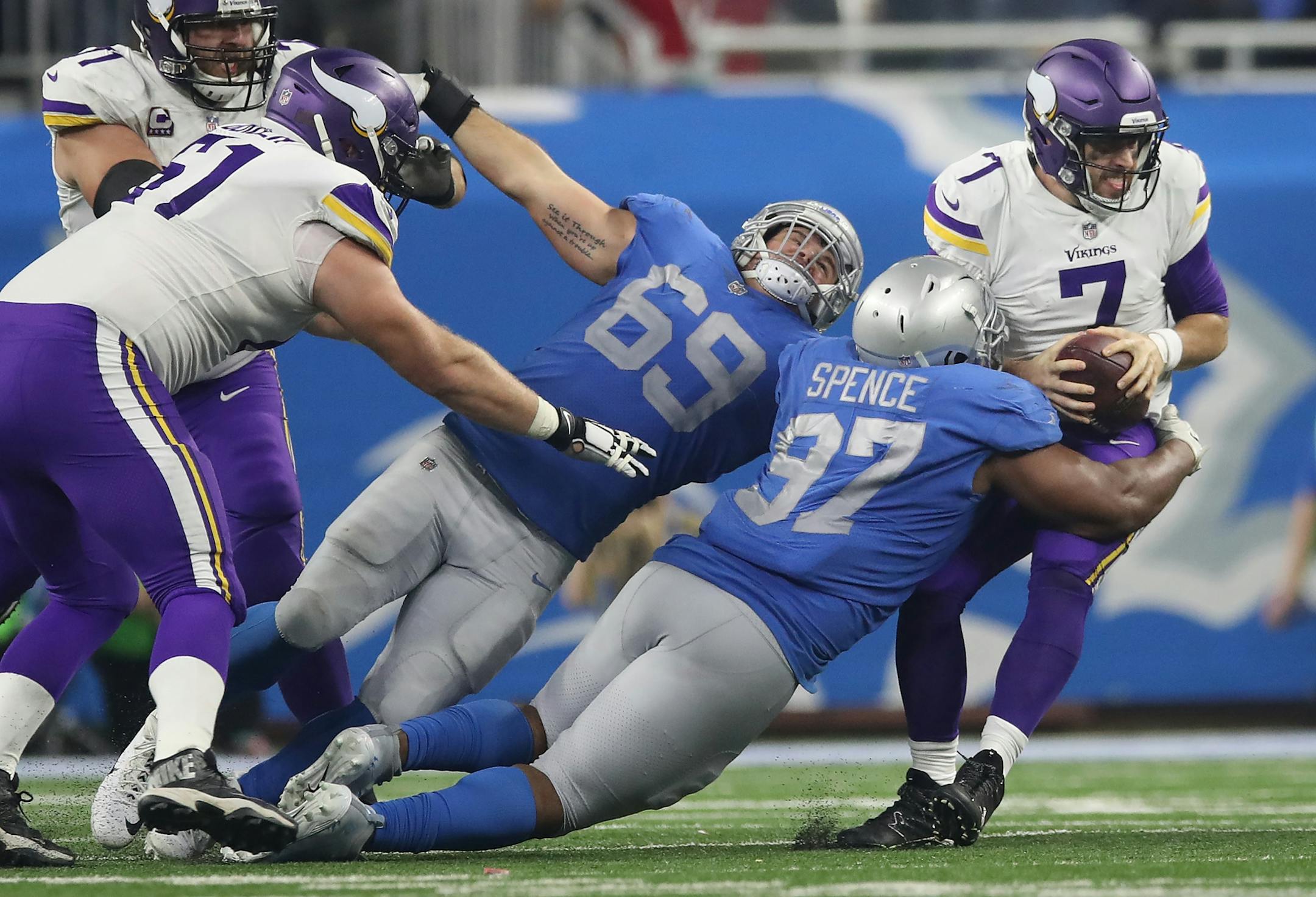 Minnesota Vikings quarterback Case Keenum (7) was sacked in the third quarter by Detroit Lions defensive tackle Akeem Spence (97) at Ford Field Thursday November 23, 2017 in Detroit , MI.