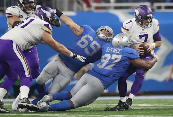 Minnesota Vikings quarterback Case Keenum (7) was sacked in the third quarter by Detroit Lions defensive tackle Akeem Spence (97) at Ford Field Thursd