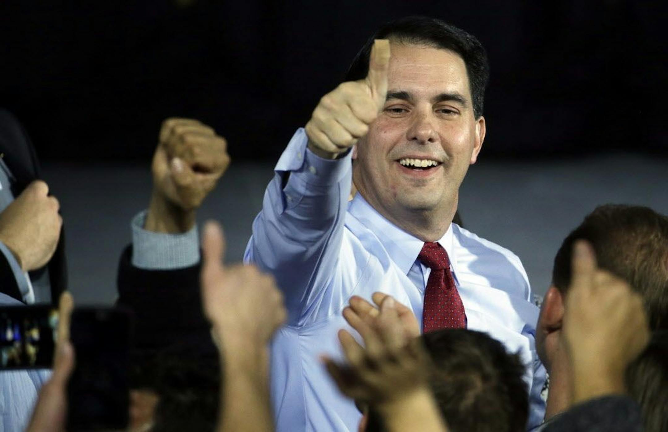 Wisconsin Republican Gov. Scott Walker gives a thumbs-up after speaking at his campaign party, Tuesday, Nov. 4, 2014, in West Allis, Wis.
