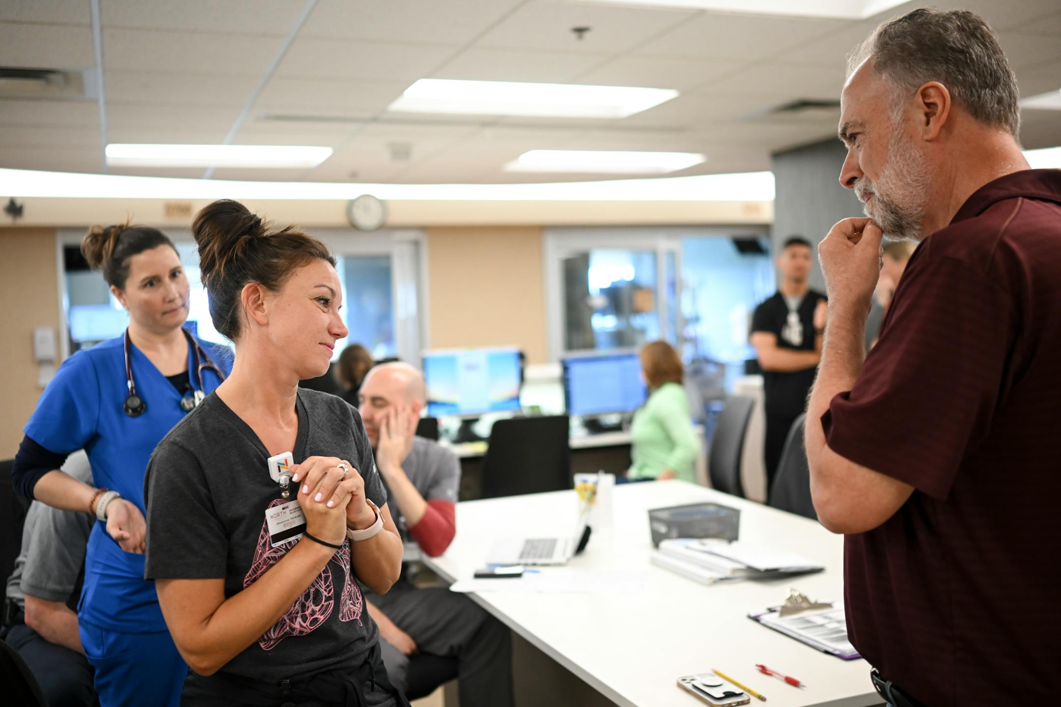 After tearfully reuniting, COVID survivor Rick Ulrich, right, and critical care nurse Holly Vilione take a quiet contemplative moment while discussing the mortality of many COVID patients who didn't survive their illness Thursday, May 11, 2023, at North Memorial Health Hospital's South Seven Intensive Care Unit in Robbinsdale, Minn.