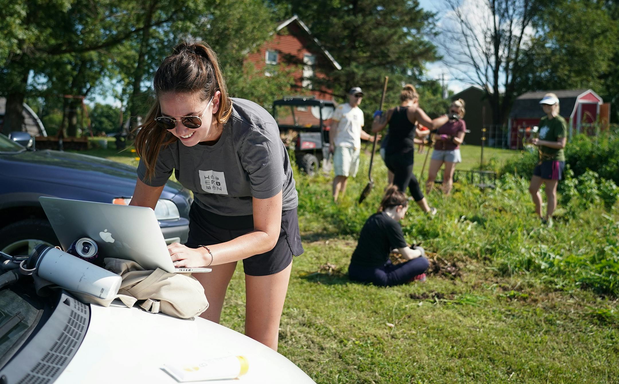Haberman employees spent much of the day at the company garden, though Jess Quinn took time out to work on her laptop. "Real life happens," she said as her colleagues worked in the garden.
