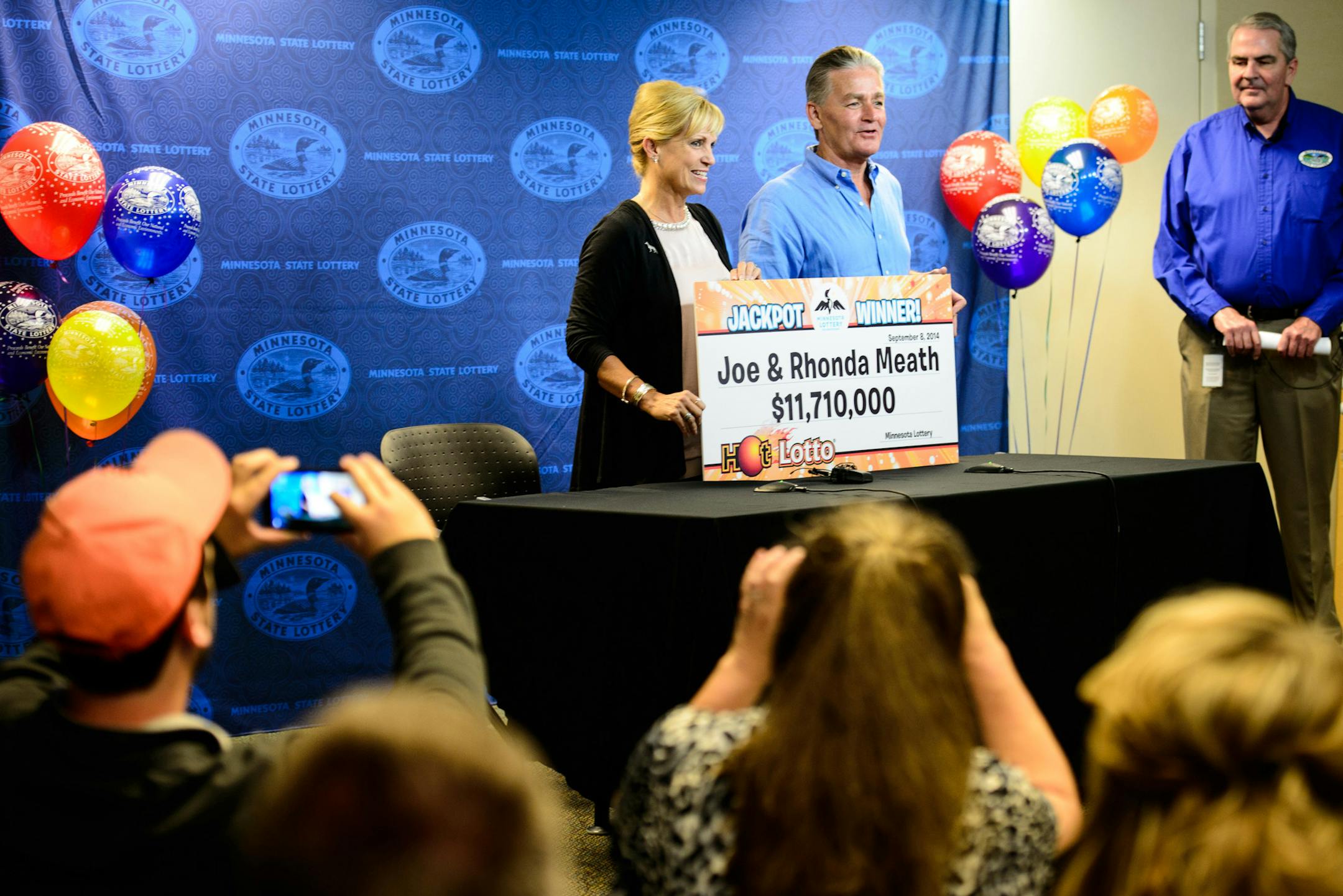 Family members took photos as Bethel couple Joe and Rhonda Meath collected their winnings. They are the latest multi-million dollar lotto winners. Minnesota Lottery director Ed Van Petten, right, announced them as winners. ] Roseville , MN -- , Monday, September 8, 2014. GLEN STUBBE * gstubbe@startribune.com