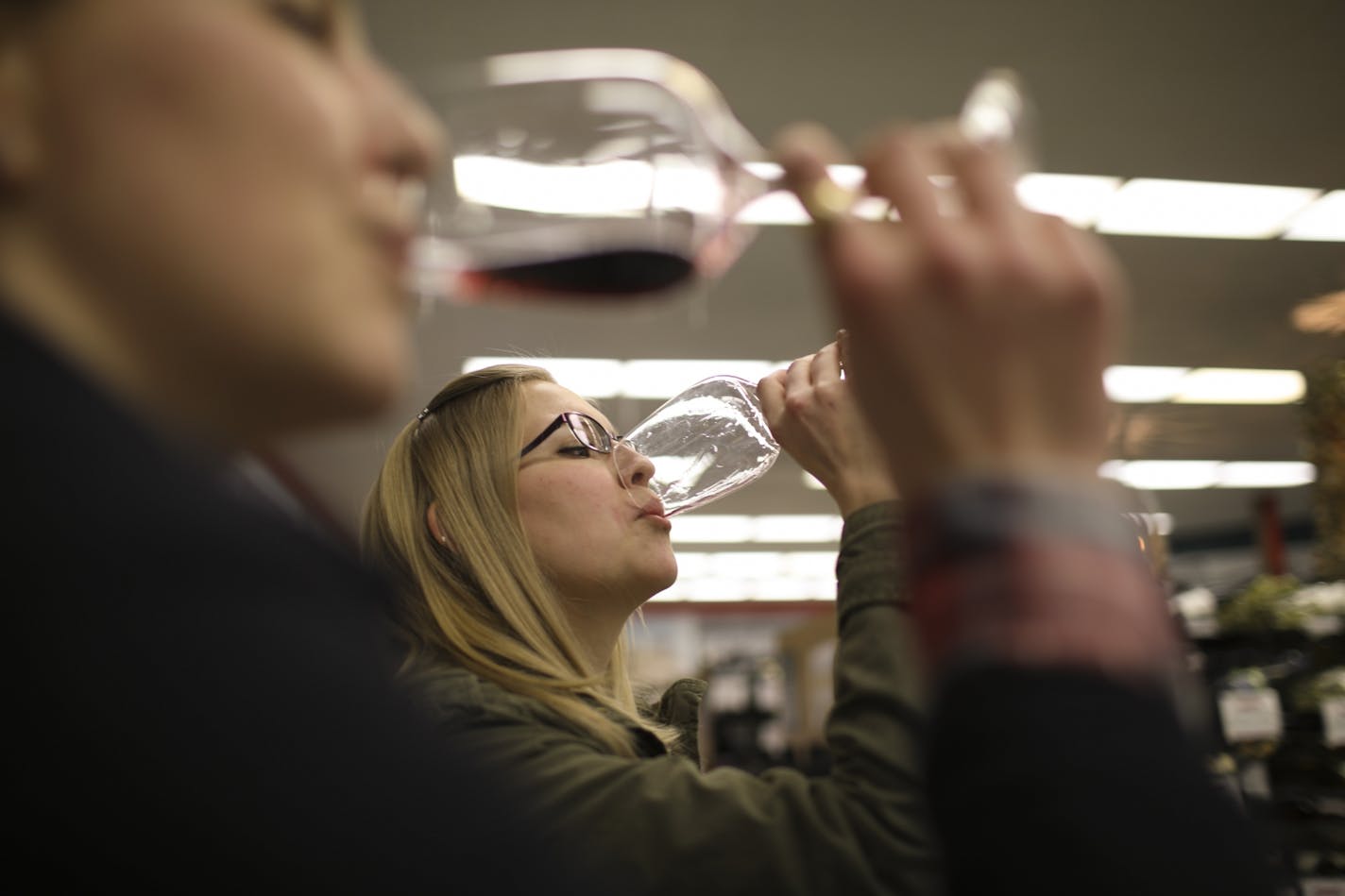 Emily Beltt, in front, and her sister, Lindsey, tasted wine while shopping at Surdyk's in Minneapolis on Tuesday afternoon. The two reflected on how life would be different once Sunday liquor sales are allowed.