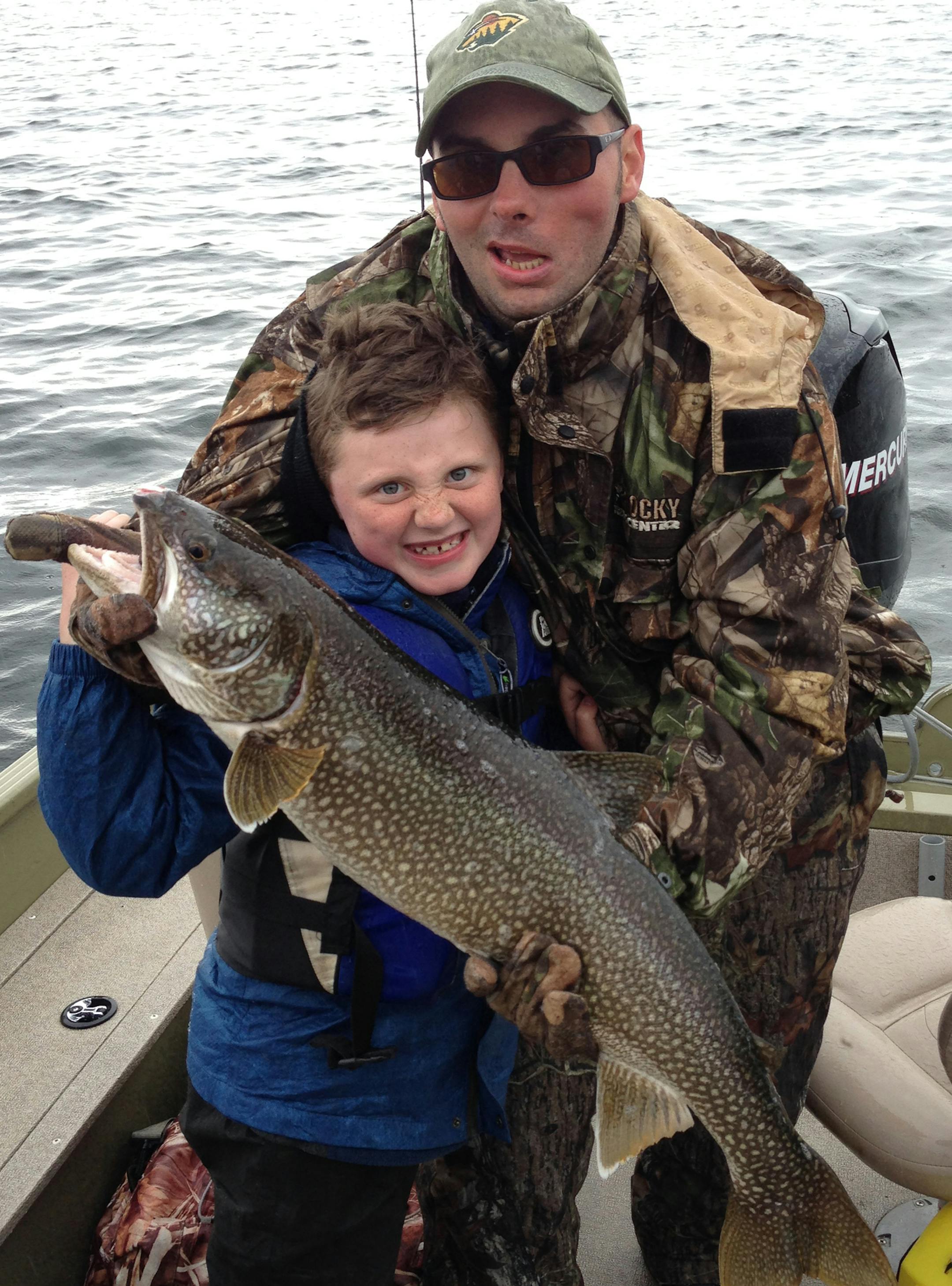 LARGE LAKER Sam Villella and his son, Kincaid, 6, of Blaine, caught this 33-inch lake trout recently on Whitefish Bay of Lake of the Woods, trolling with Rapala.
