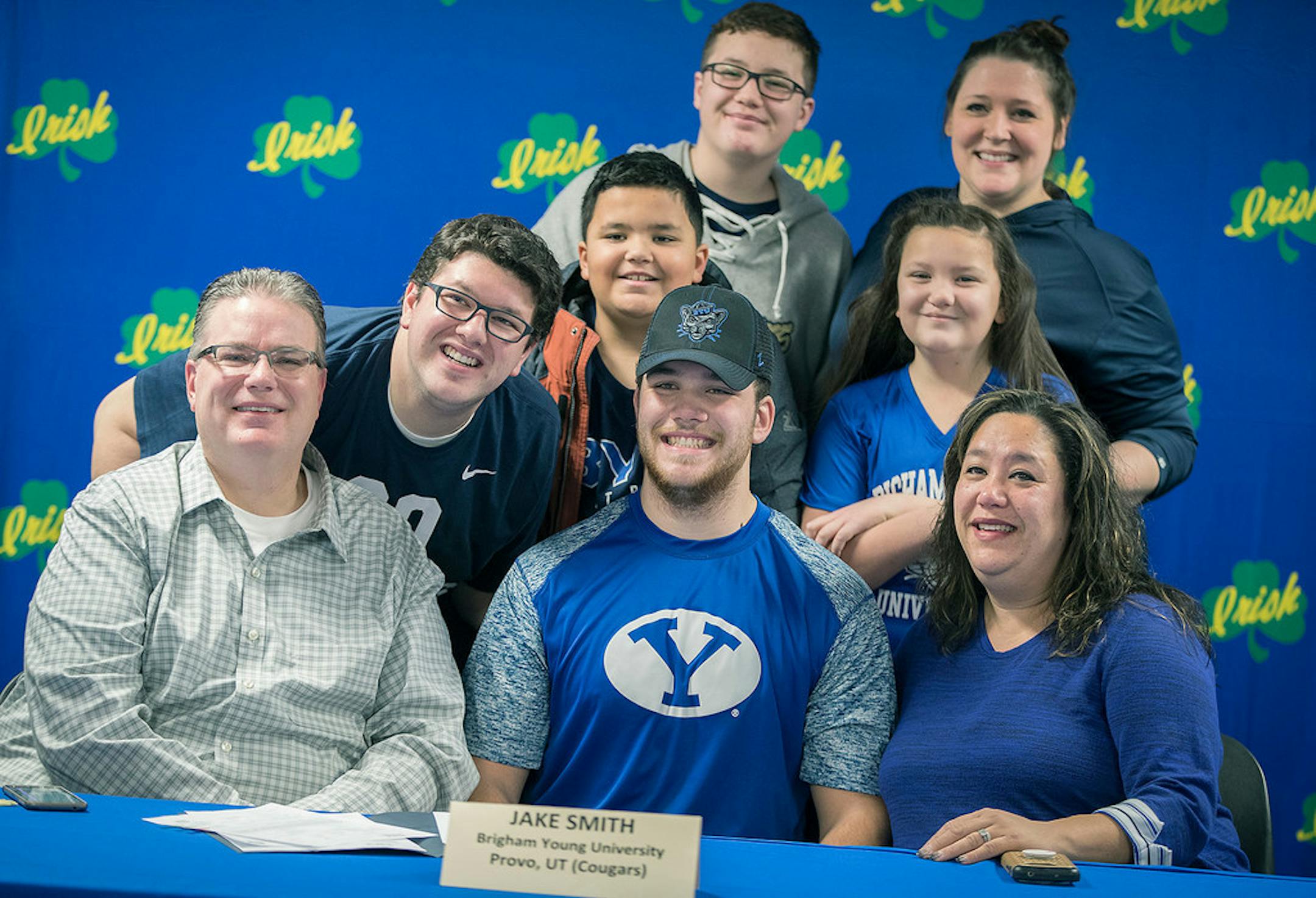 Rosemount's Jacob Smith was all smiles as he posed for pictures surrounded by his family after he signed to play football for Brigham Young University during a ceremony Wednesday at his high school.