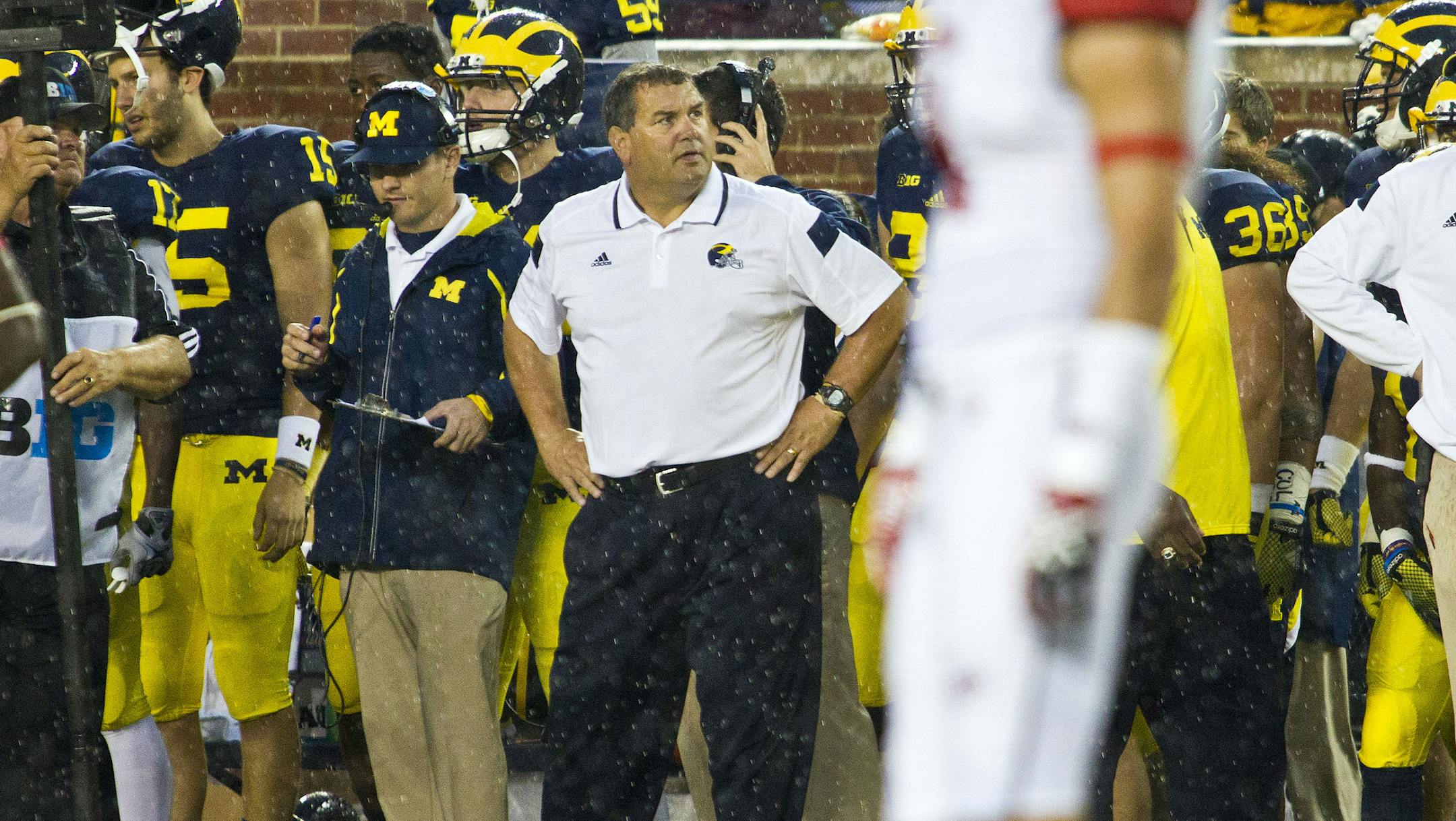 Michigan head coach Brady Hoke, center background, stands on the sideline in the fourth quarter of an NCAA college football game against Utah in Ann Arbor, Mich., Saturday, Sept. 20, 2014. (AP Photo/Tony Ding)