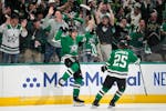 Dallas Stars center Roope Hintz, left, celebrates with left wing Joel Kiviranta (25) after scoring in the first period of Game 2 of an NHL hockey Stan
