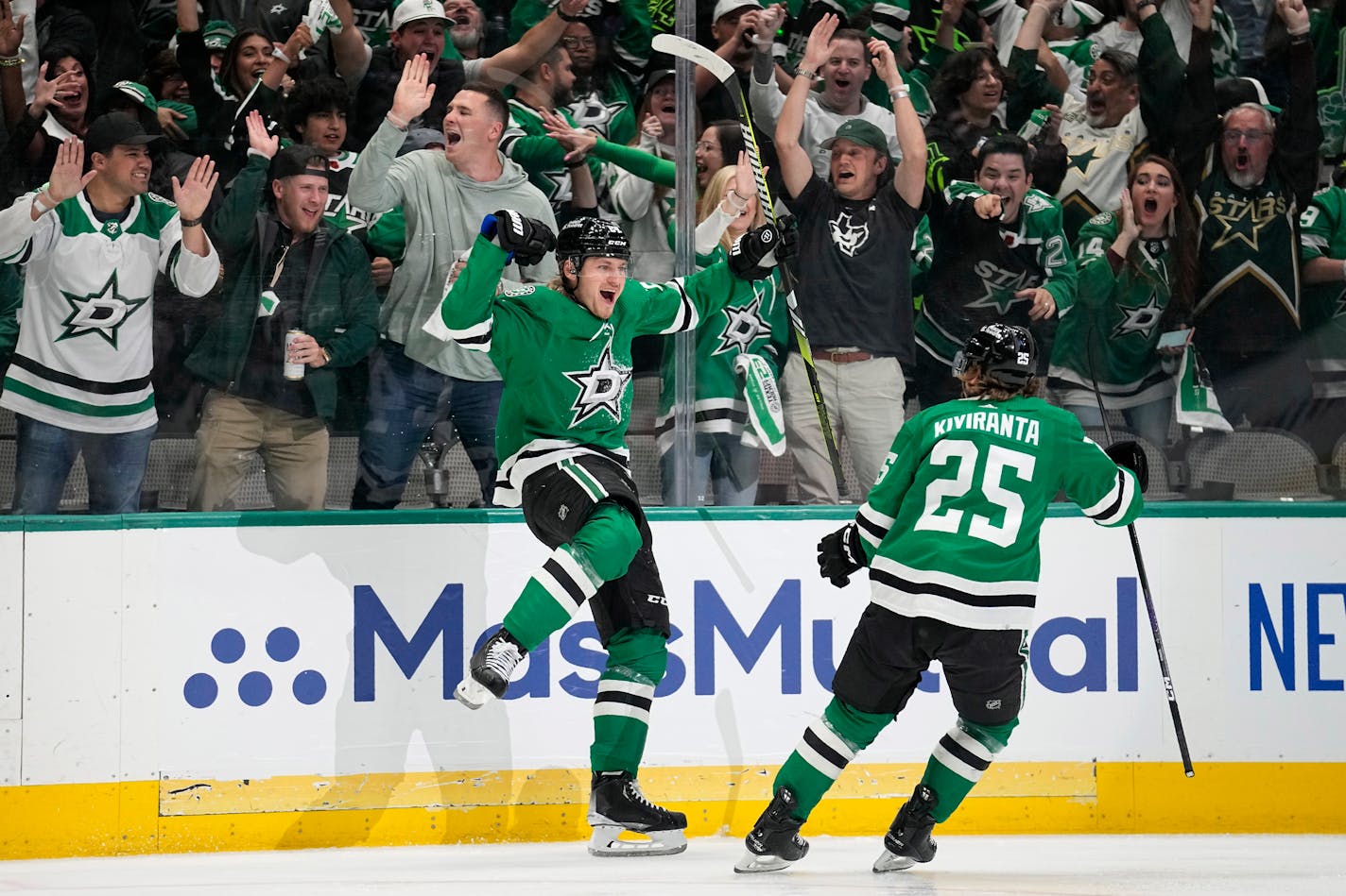 Dallas Stars center Roope Hintz, left, celebrates with left wing Joel Kiviranta (25) after scoring in the first period of Game 2 of an NHL hockey Stanley Cup first-round playoff series against the Minnesota Wild, Wednesday, April 19, 2023, in Dallas. (AP Photo/Tony Gutierrez)