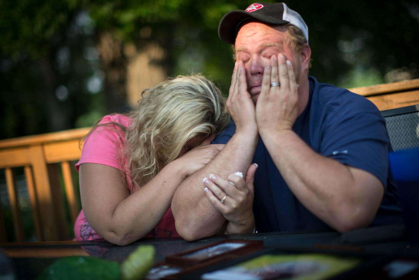 Shelley Fenton cried into her husband Al Fenton's arm as he tearfully told the story about his two-year-old son Benny's death while riding with him on a skid loader on a farm he worked at. Photographed on Wednesday, June 8, 2015, in New Richland, Minn. ] RENEE JONES SCHNEIDER � reneejones@startribune.com