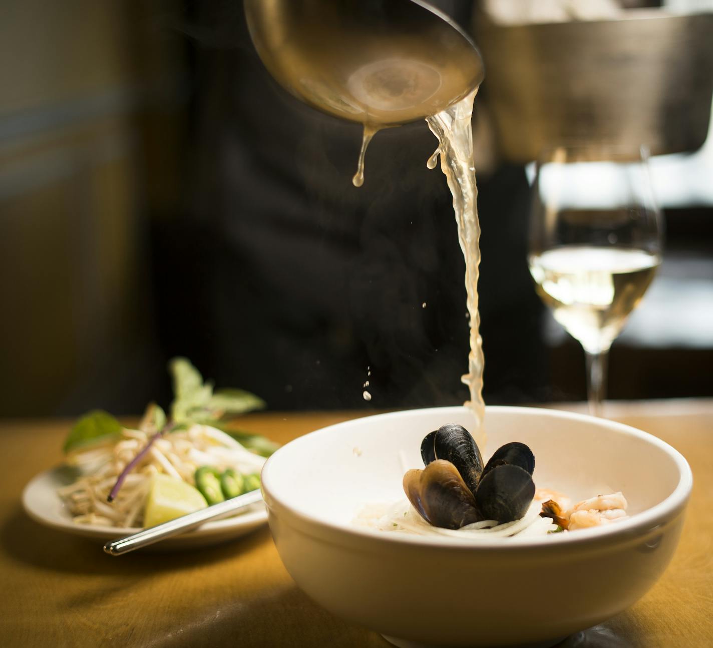 Hai Truong poured broth to complete his Seafood Pho at Ngon Vietnamese Bistro, which is made with squid, shrimp, mussels and house made shrimp balls.