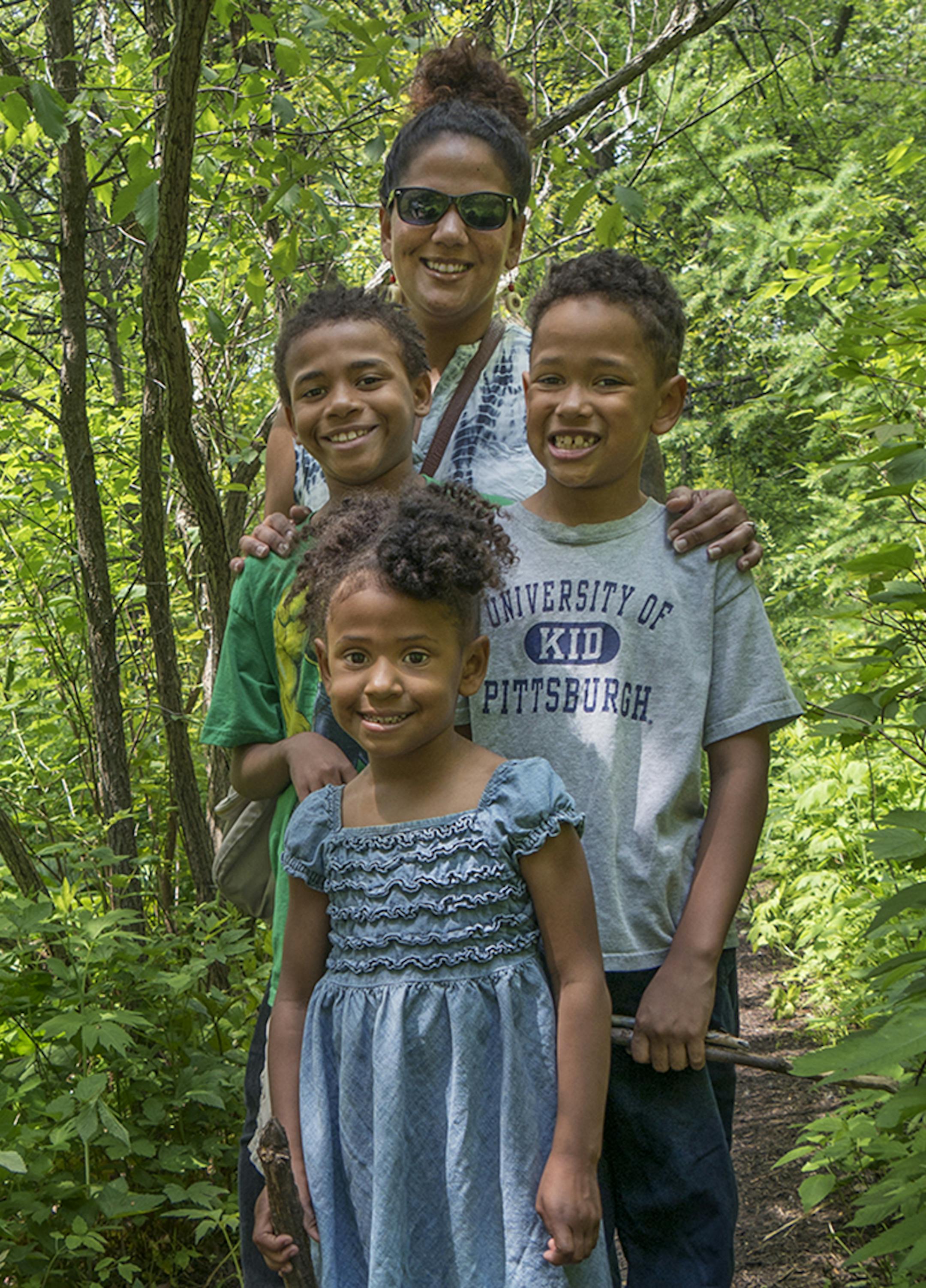 Photo by Heather Munro, Special to the Star Tribune Danielle Mkali of Minneapolis and her children, Kahlil, Ezrah and Naima, admired pink ladyslippers that came into bloom last week at the Eloise Butler Wildflower Garden in Wirth Park in Minneapolis.