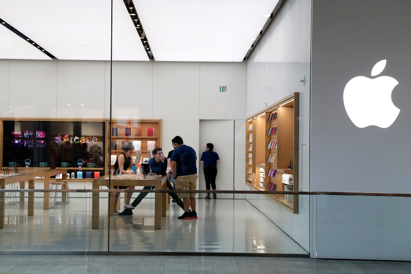 Apple employees inside a closed Apple store in Miami.