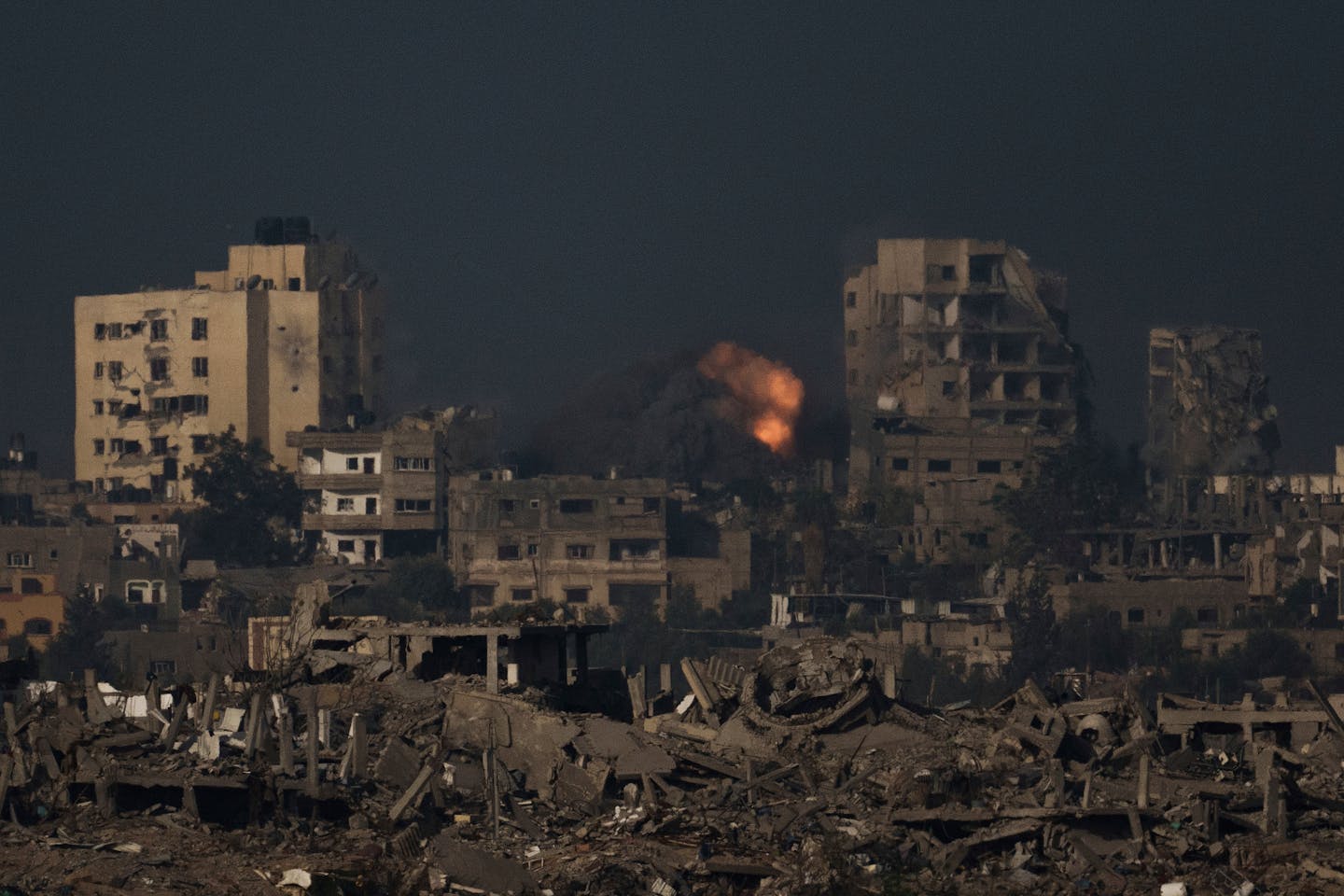 An explosion is seen following an Israeli bombardment in the Gaza Strip, as seen from southern Israel, Thursday, Nov. 23, 2023. (AP Photo/Leo Correa)