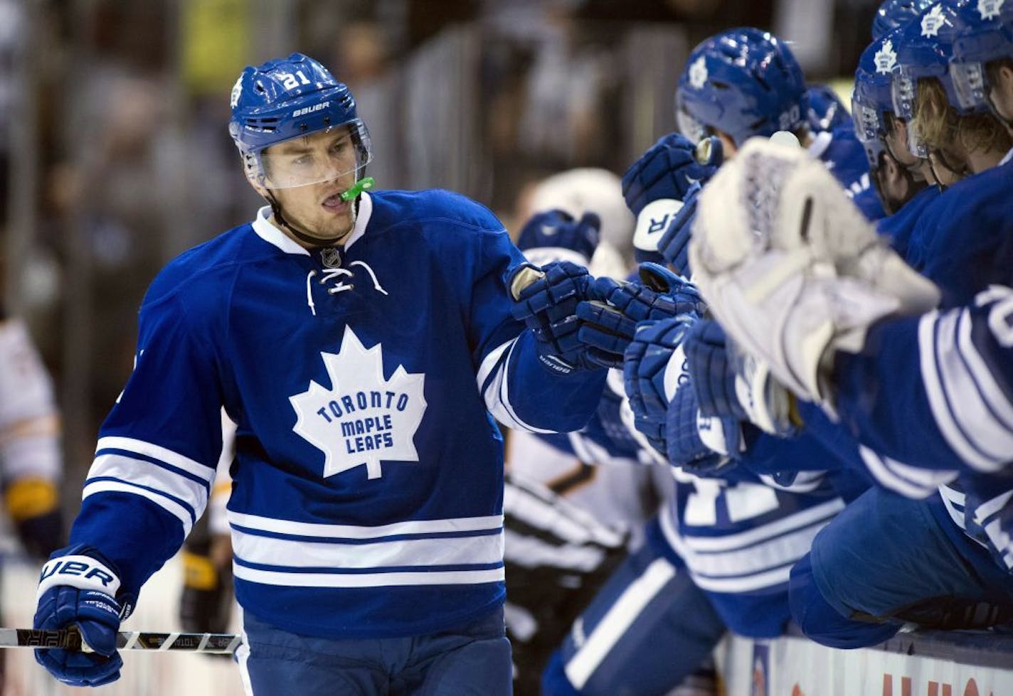 Toronto Maple Leafs left winger James van Riemsdyk is congratulated by teammates after scoring against the Buffalo Sabres during the third period of their NHL hockey game, Thursday, Feb. 21, 2013, in Toronto.