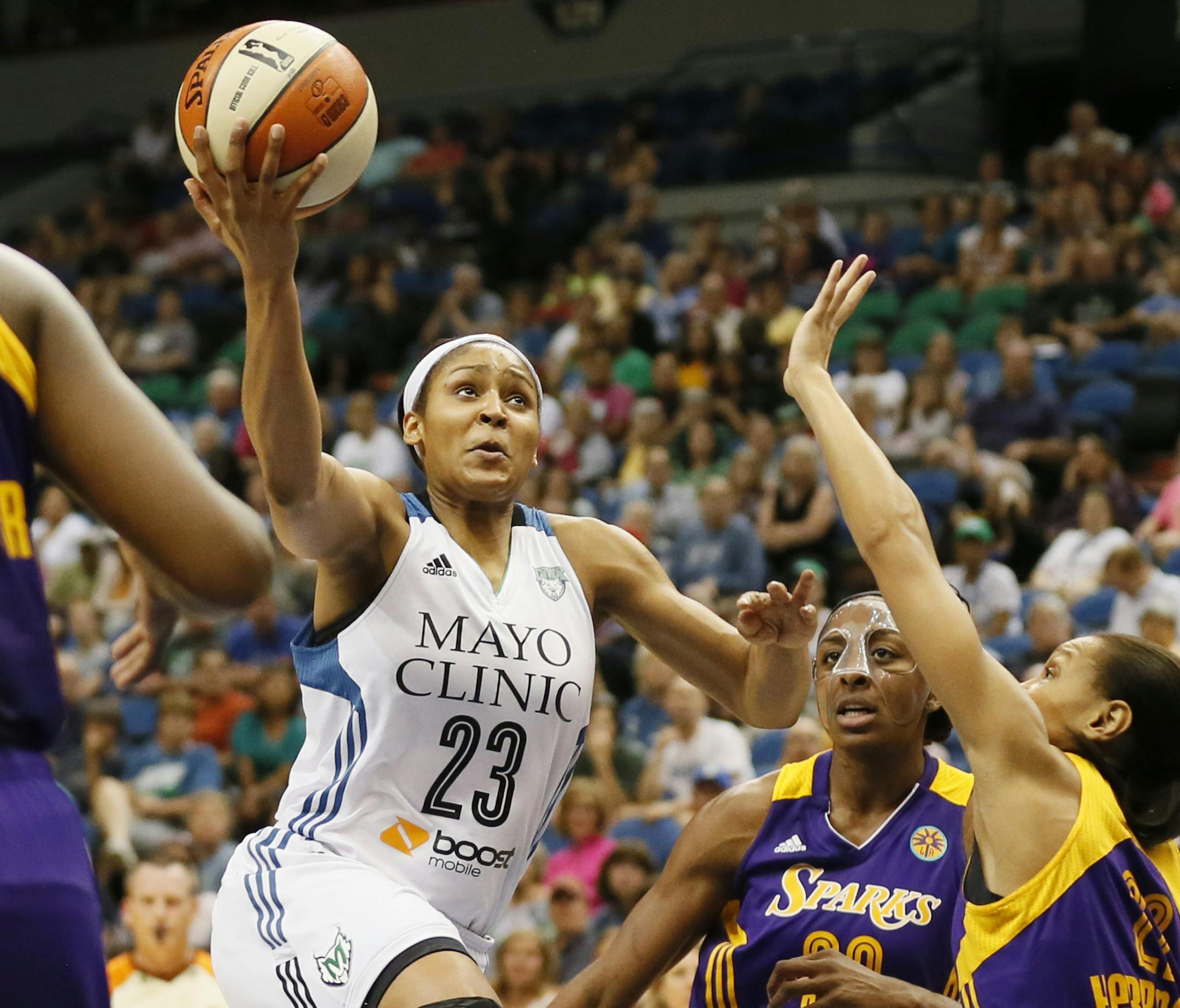 Maya Moore drove to the basket on Nneka Ogwumike, and Armintie Herrington of the Sparks during WNBA action between the Minnesota Lynx and Los Angeles Sparks at Target Center Tuesday July 8th 2014 in Minneapolis, MN. ] Jerry Holt Jerry.holt@startribune.com
