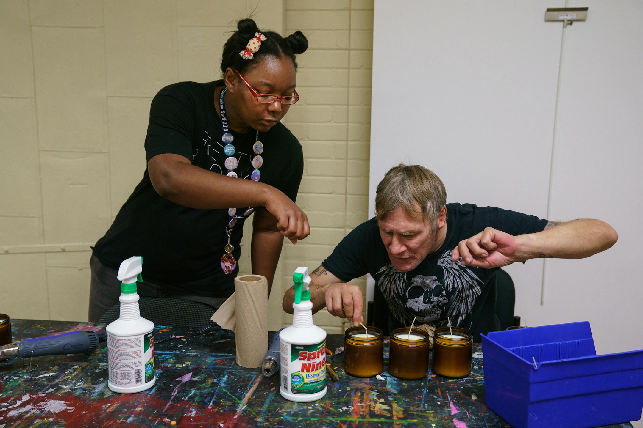 Kai Oceans, left, workshop facilitator, and resident Sean Toal make candles as part of a gift box business that brings money into the Project Home organization on Aug. 28, 2019 in Philadelphia. (Jessica Griffin/The Philadelphia Inquirer/TNS) ORG XMIT: 1415266 ORG XMIT: MIN1909060337526782