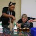 Kai Oceans, left, workshop facilitator, and resident Sean Toal make candles as part of a gift box business that brings money into the Project Home org