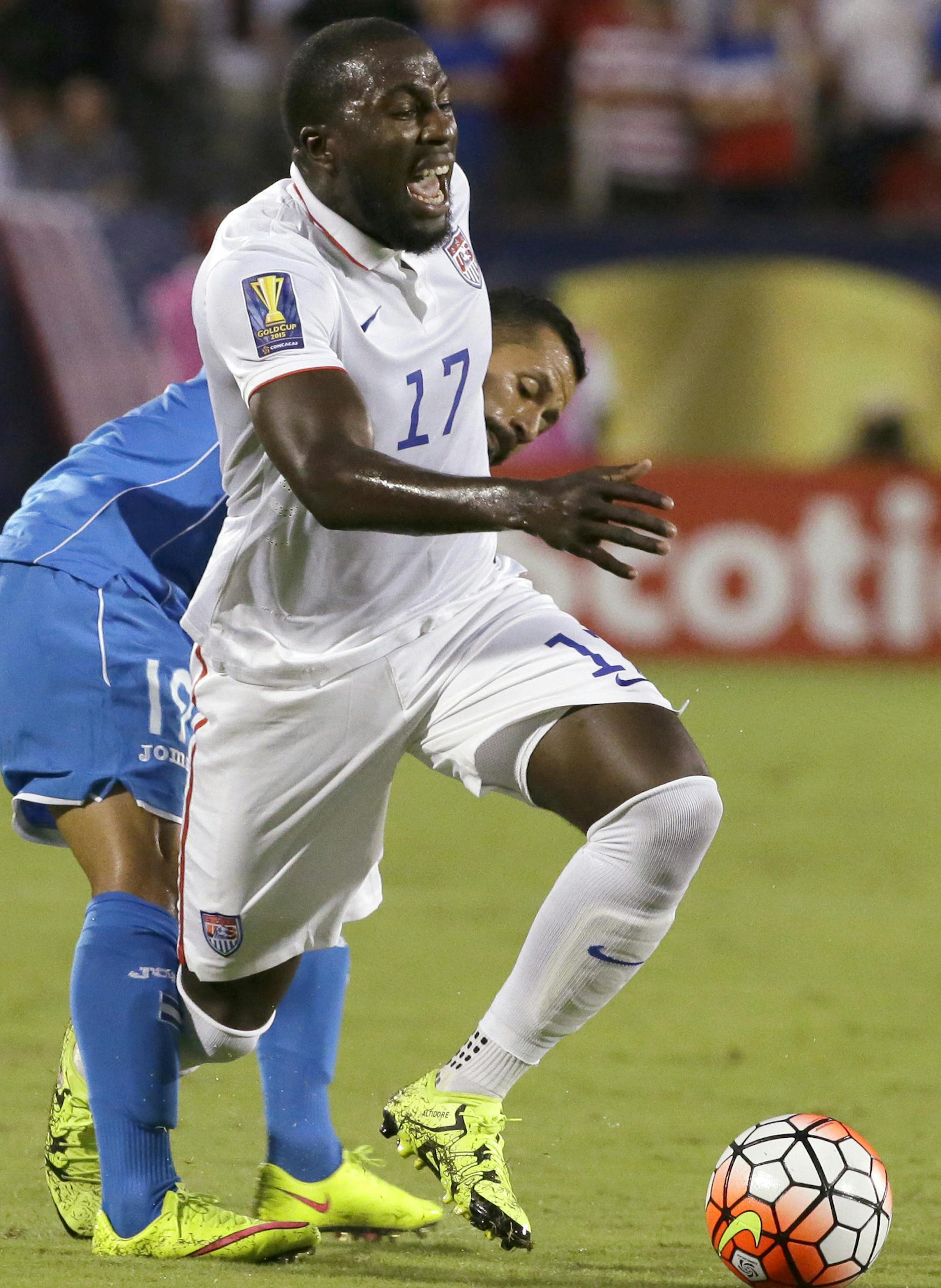 United States' Jozy Altidore (17) is tripped by Honduras' Alfredo Mejia (19) during the first half of a CONCACAF Gold Cup soccer match in Frisco, Texas, Tuesday, July 7, 2015. (AP Photo/LM Otero)