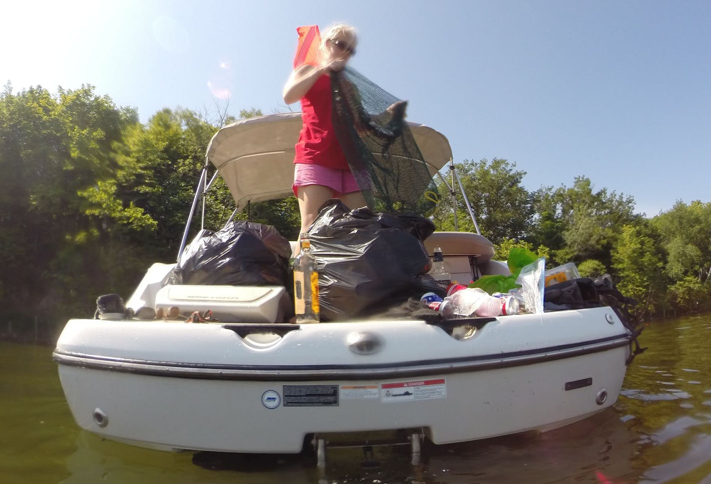 Submitted photo of volunteers cleaning up trash along Big Island on Lake Minnetonka.