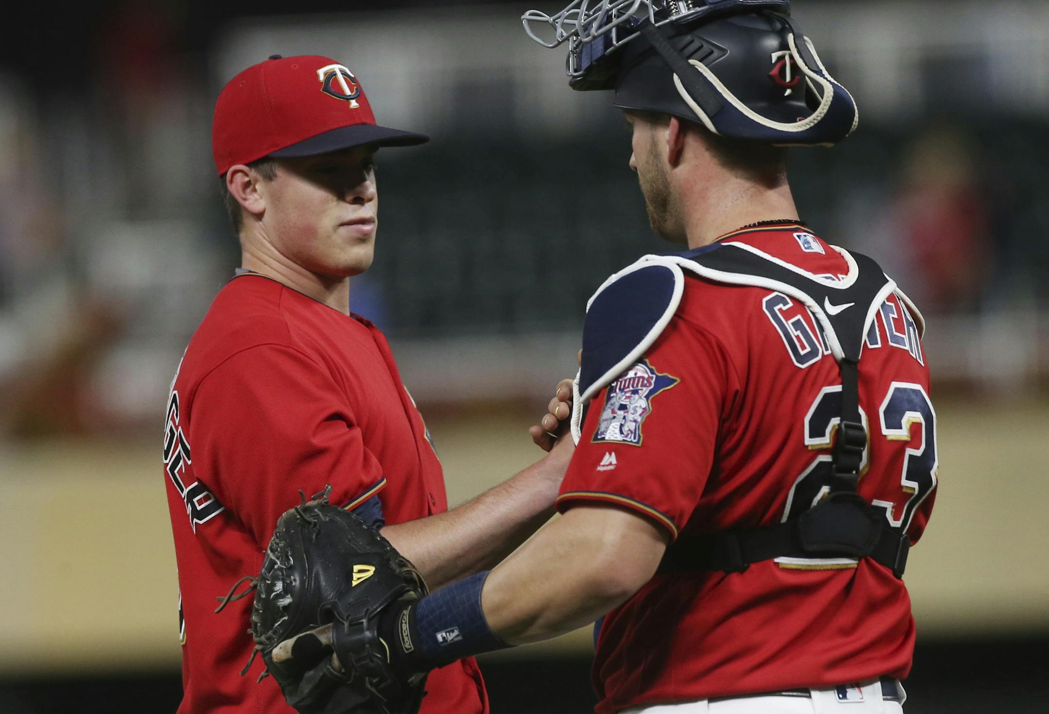 Minnesota Twins pitcher Trevor Hildenberger, left, and catcher Mitch Garver celebrate the Twins' 10-6 win over the Kansas City Royals in a baseball game Friday, Sept. 7, 2018, in Minneapolis. (AP Photo/Jim Mone)
