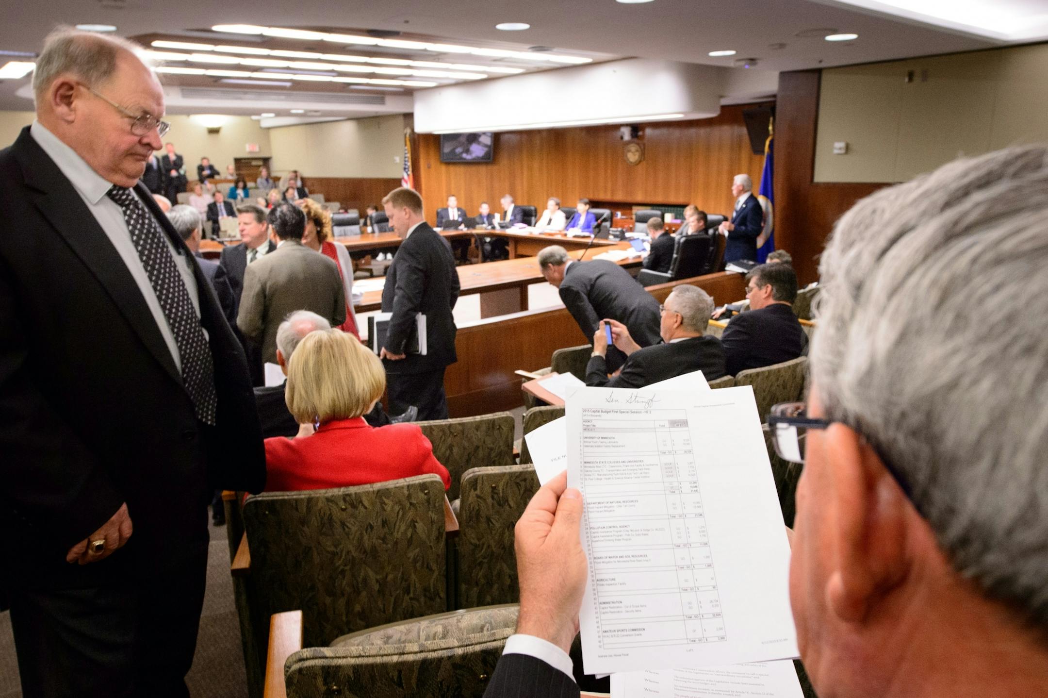 Senator Bill Weber read through a funding bill at the start of the session in the Senate. On the left is assistant Minority Leader Sen. Gary Dahms.