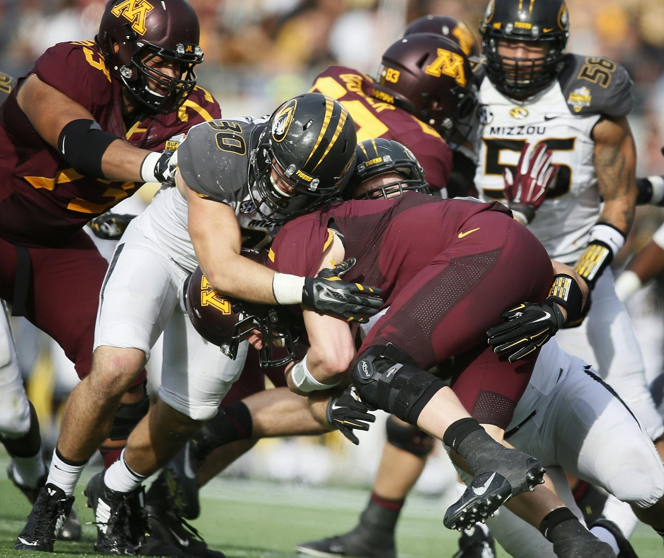 Mitch Leidner (7) was stopped for no gain in the fourth quarter by Missouri Tigers linebacker Michael Scherer (30) in the third quarter.