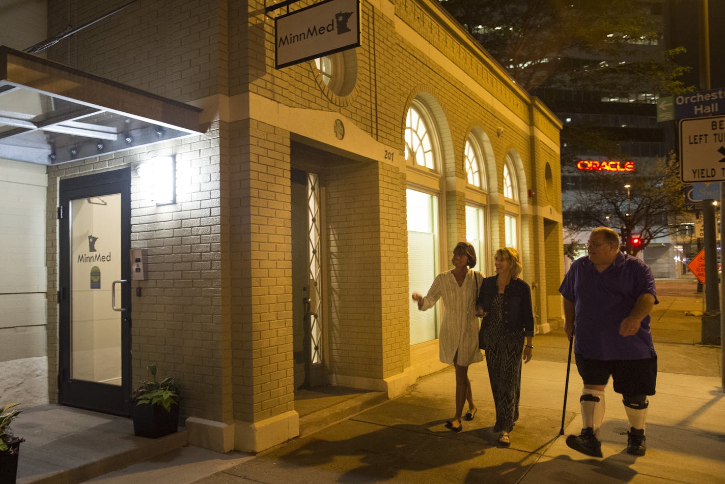 From left, Kim Kelsey, Kathy Engstrom and Patrick McClellan made their way into MinnMed for a medical marijuana appointment just after midnight on Wednesday morning. Kelsey and Engstrom both have sons suffering from epilepsy and McClellan uses marijuana to treat violent spasms caused by muscular dystrophy. ] Aaron Lavinsky &#x2022; aaron.lavinsky@startribune.com Minnesota Medical Solutions has booked its first medical marijuana appointments just after midnight July 1, 2015, as soon as the drug c