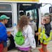 Metro Transit employee Danielle Julkowski, in the yellow vest, directed passengers to a State Fair express bus at the County Road 73 Park and Ride in 