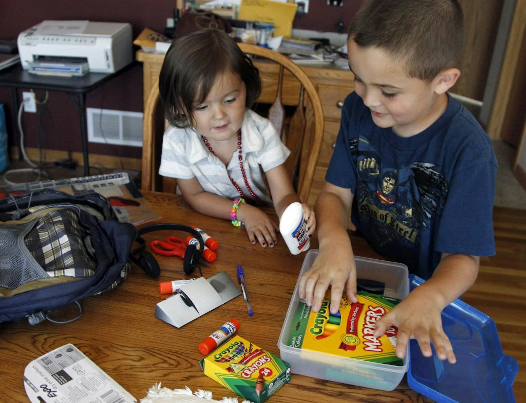 By shopping early -- and smartly -- Karen Beecher paid just $10 for school supplies for son Conner, right. Even preschooler Olivia, 3, got a backpack.