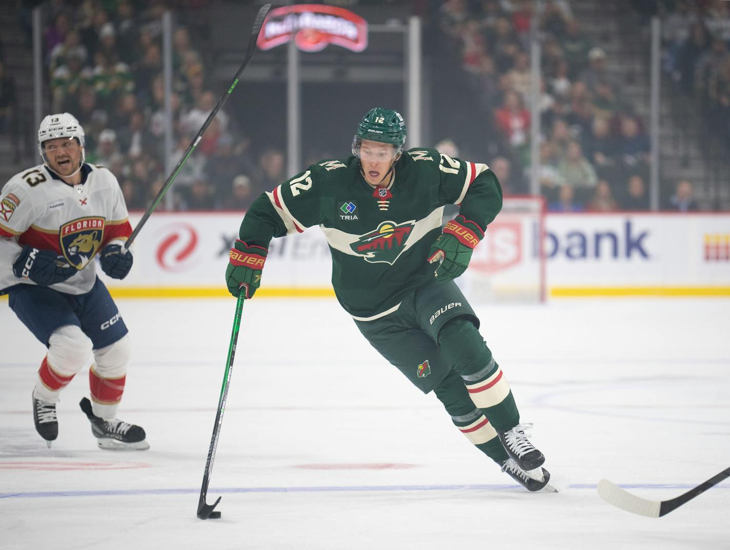 Minnesota Wild left wing Matt Boldy (12) brought the puck into the zone in the first period. The Minnesota Wild faced the Florida Panthers in an NHL hockey game Thursday night, October 12, 2023 at Xcel Energy Center in St. Paul.