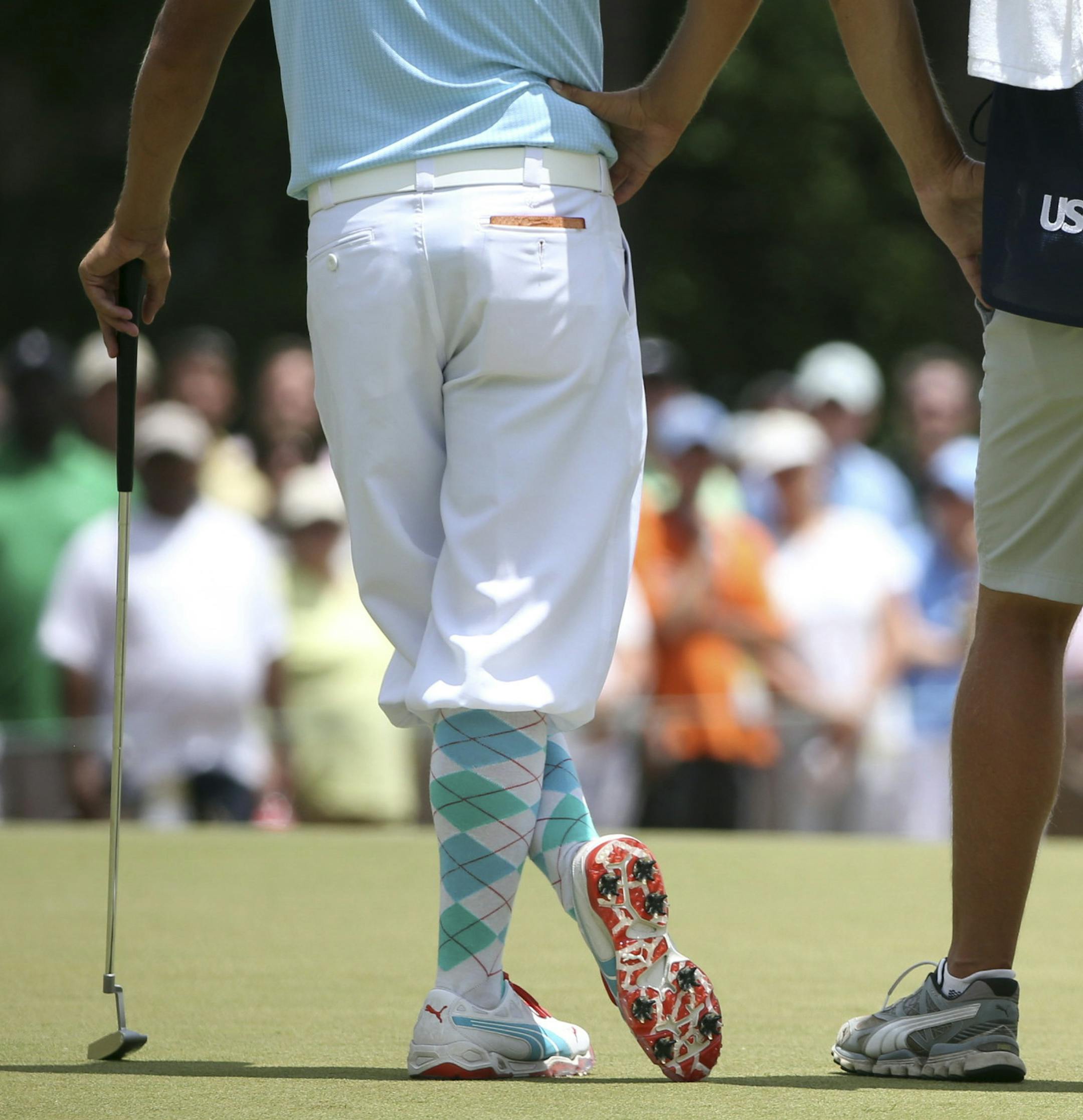 Rickie Fowler of the U.S., left, stands with his caddie and the Jordan Spieth's caddie during the first round of the U.S. Open at the Pinehurst Resort, in Pinehurst, N.C., June 12, 2014. (Doug Mills/The New York Times)