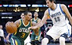 Utah Jazz's George Hill, left, drives around Minnesota Timberwolves' Nemanja Bjelica of Serbia in the first quarter of an NBA basketball game Monday, 